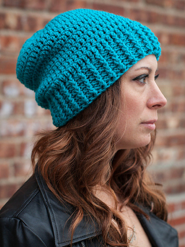 A woman wearing a crochet hat.