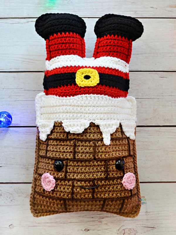 A crocheted santa claus pillow.