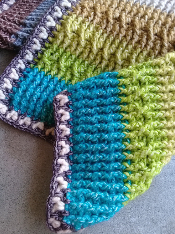 Festive crocheted dishcloths on a table.