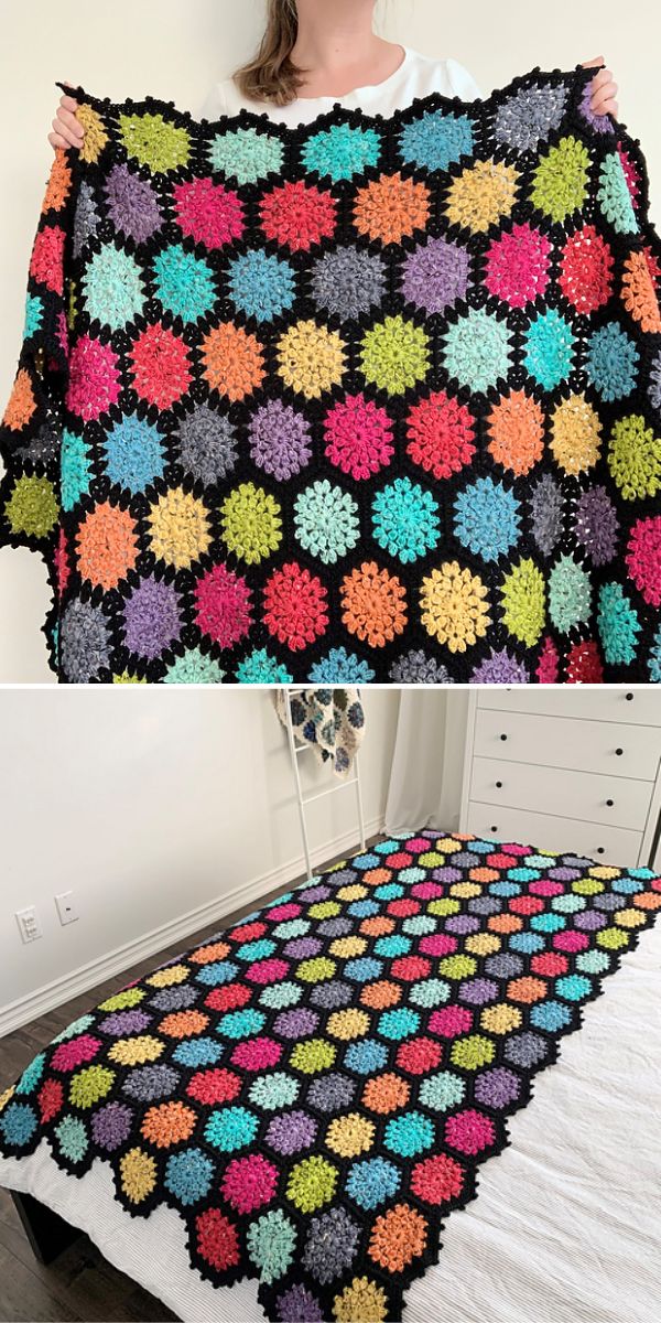 A woman is proudly displaying a vibrant crocheted afghan, crafted with intricate crochet hexagons.