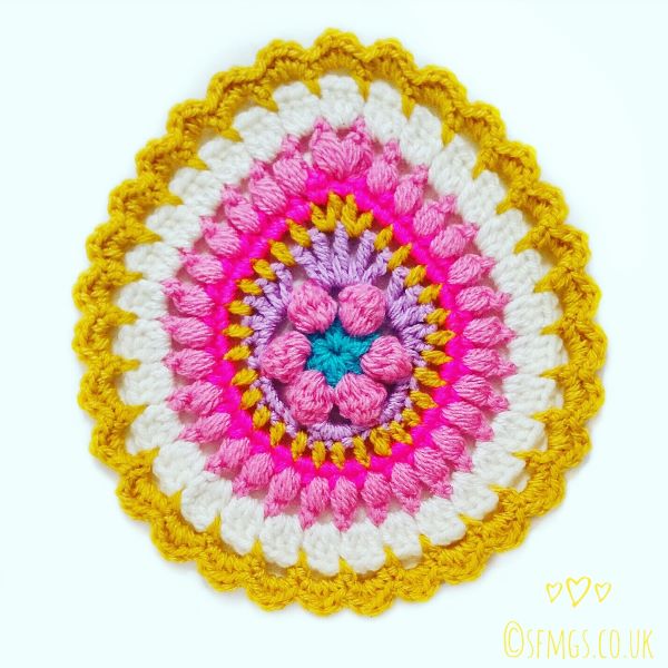 colorful egg-shaped mandala with scalloped edging