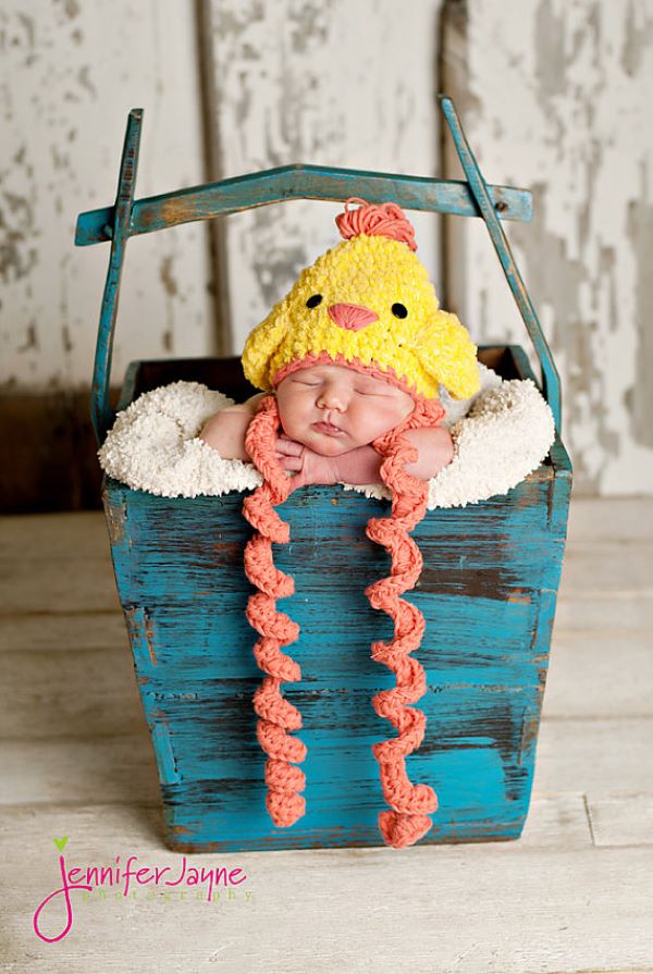 baby in a chicken-shaped crochet hat