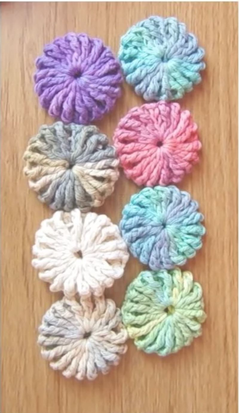 A group of crocheted flowers on a table.