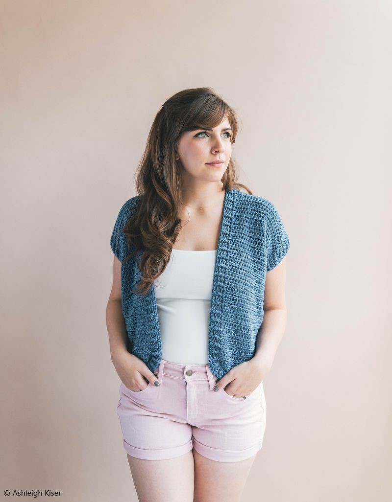 a short blue crochet cardigan