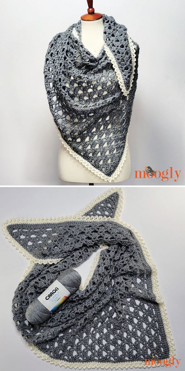 A gray triangular crocheted shawl with a delicate white border displayed on a mannequin and laid flat with a skein of gray yarn, showcasing the intricate design often found in lacy crochet shawls.