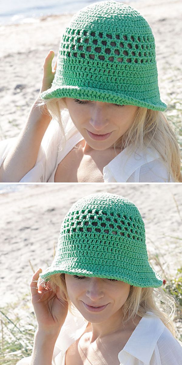 A person wearing a light green crocheted bucket hat and a white shirt, sitting outdoors near a beach with a colorful crochet star blanket draped beside them.