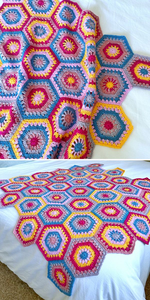A colorful crochet star blanket with hexagonal patterns in pink, blue, yellow, and white is draped and spread out on a white bed.
