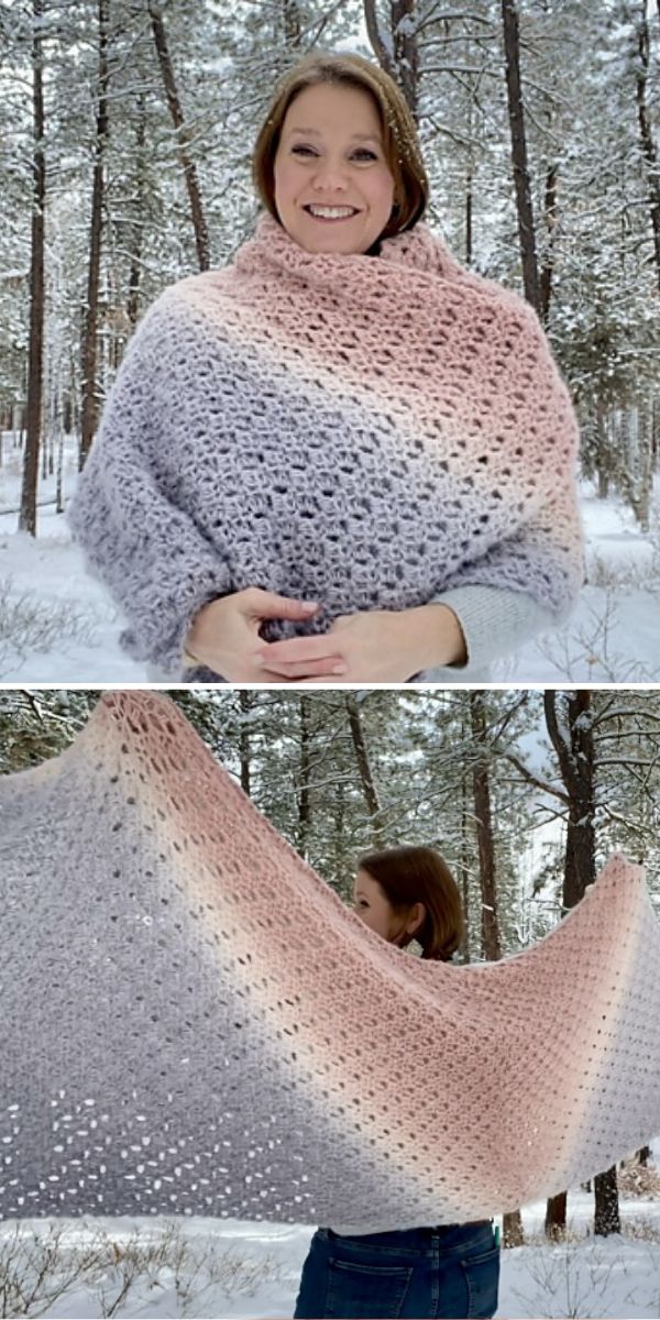 A woman is holding a rectangular crocheted shawl in the snow.