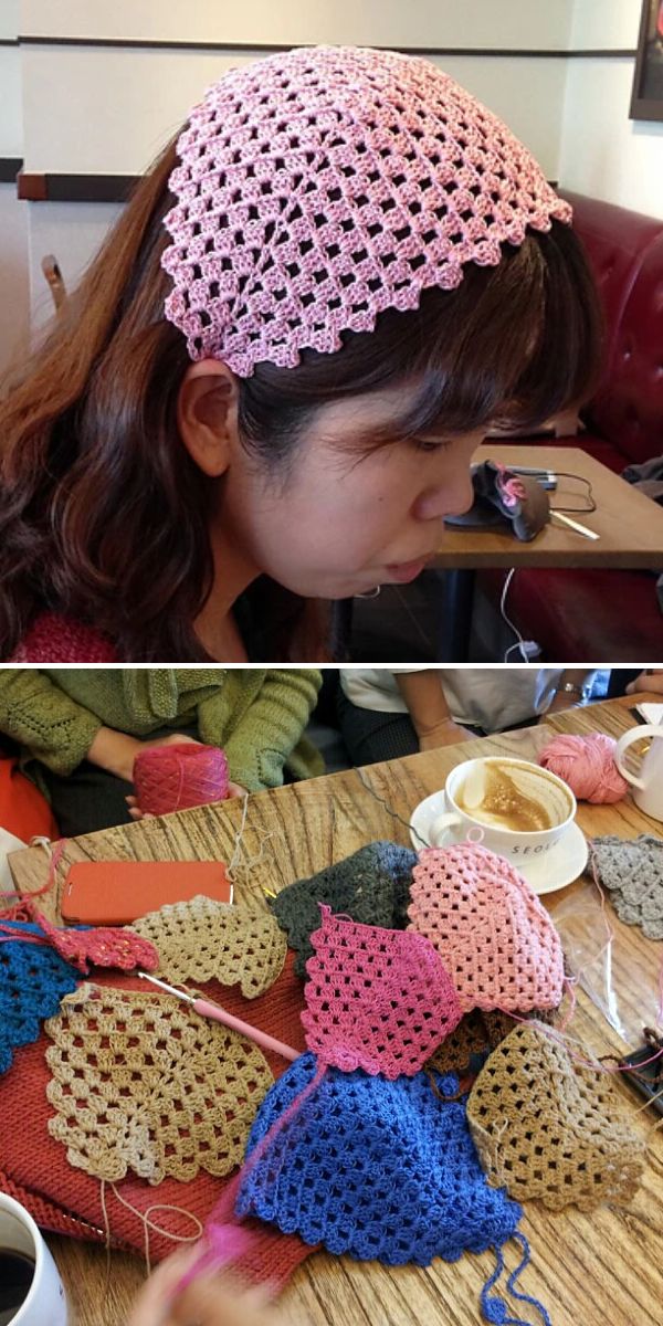 A woman wears a pink crocheted hair cover; below, several crocheted pieces and yarn are spread out on a table near coffee cups.