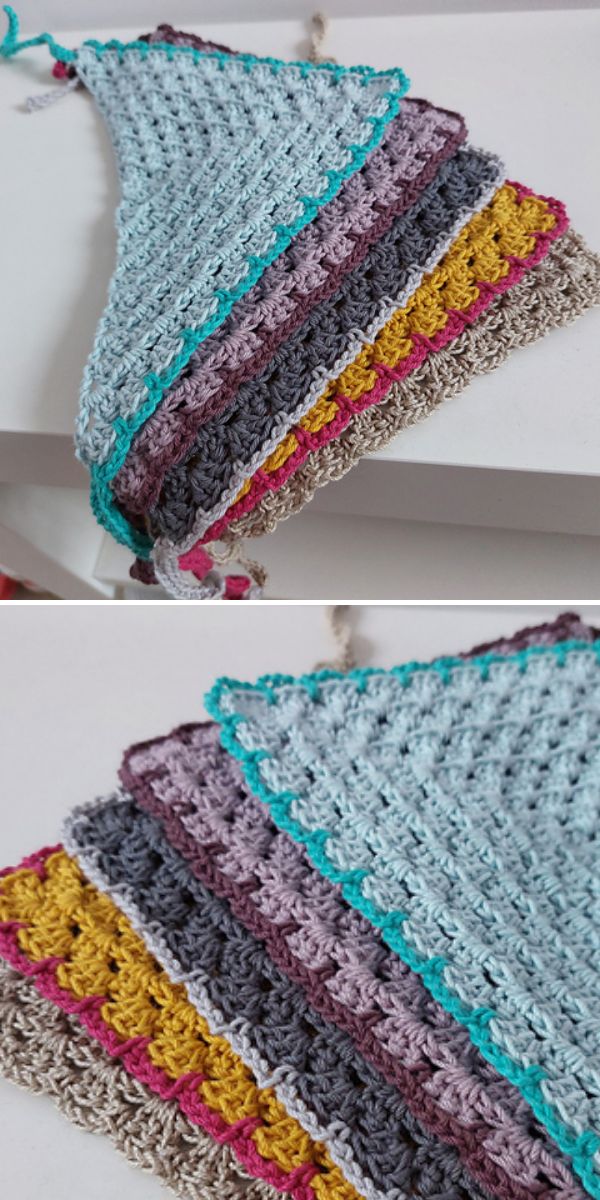 A crocheted triangular piece with textured stitches, featuring stripes in light blue, grey, purple, yellow, pink, and beige.