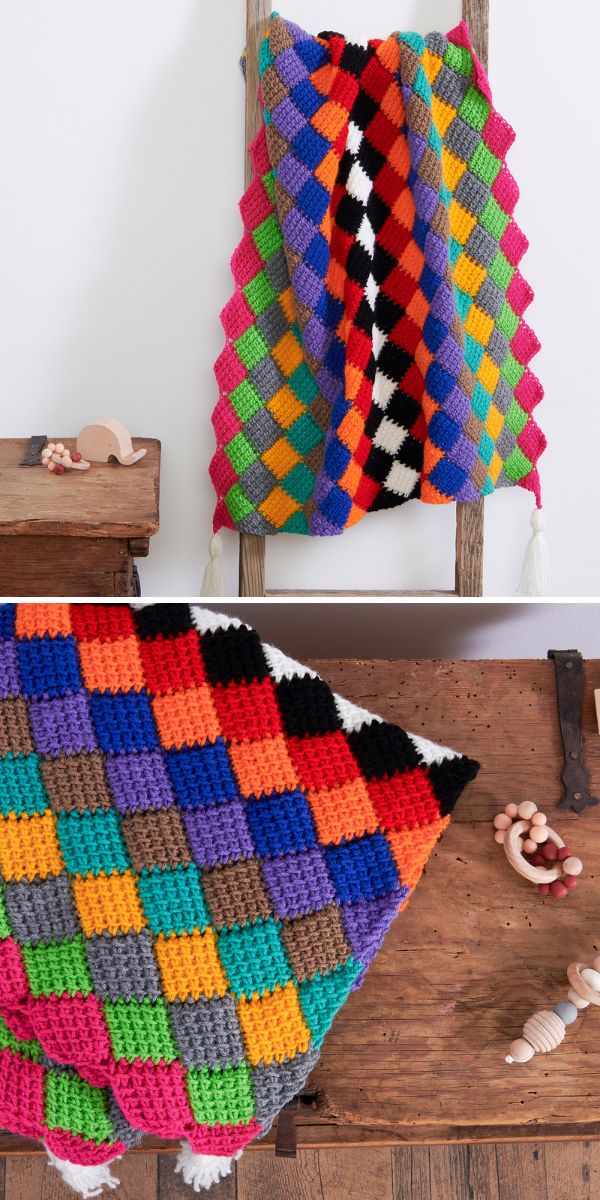 A tunisian crochet entrelac afghan on a wooden surface.