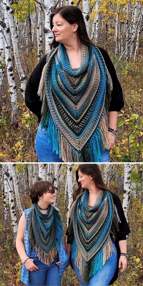 A woman is standing in front of a tree with a crochet shawl.