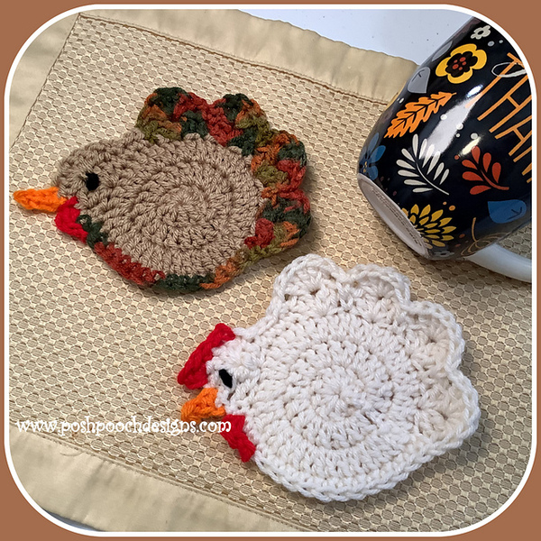 Two crocheted turkey coasters next to a mug.