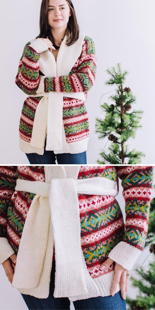A woman is standing in front of a christmas tree wearing a sweater.