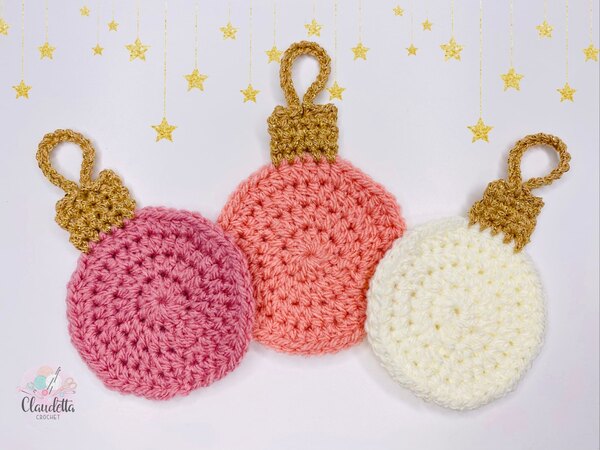 Three crocheted christmas ornaments on a white background.