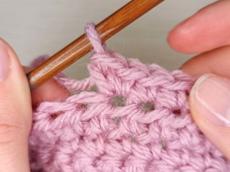 a crochet increase shown on a piece of fabric