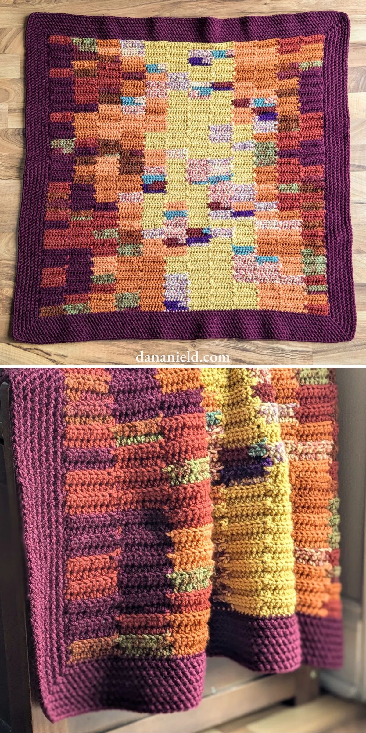 A multicolored crochet blanket featuring a geometric pattern with warm hues of orange, yellow, purple, and green, displayed laid flat and draped over a chair.