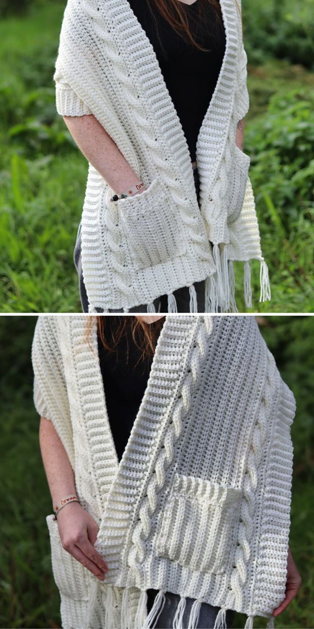 A person wearing a cream-colored, crochet shawl with front pockets and fringe, standing outdoors. The shawl features a cable-knit pattern.