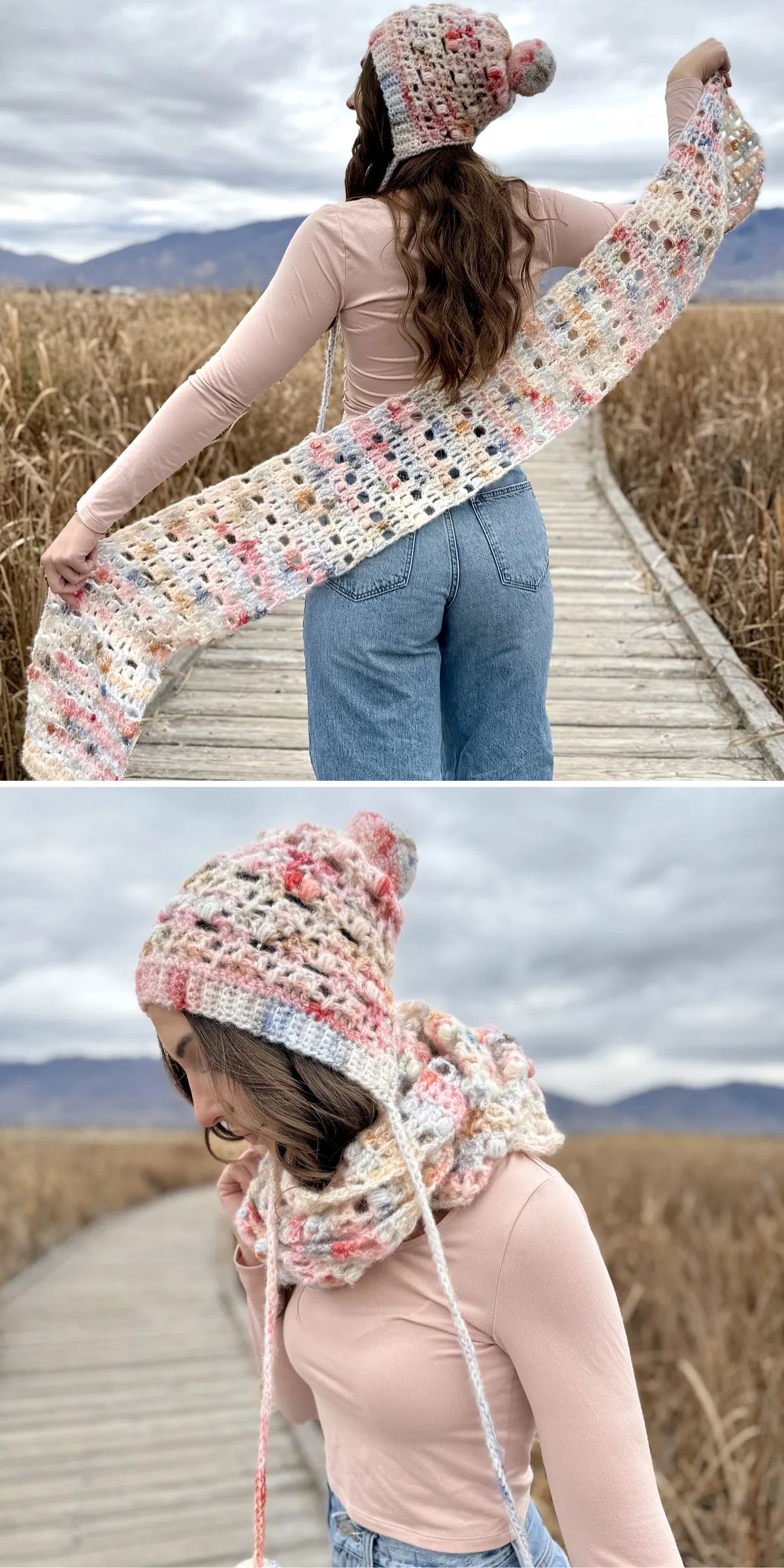 A woman on a boardwalk wears a pink top, blue jeans, and a matching crocheted hat and scarf in pastel colors, holding and wrapping the scarf around her neck.