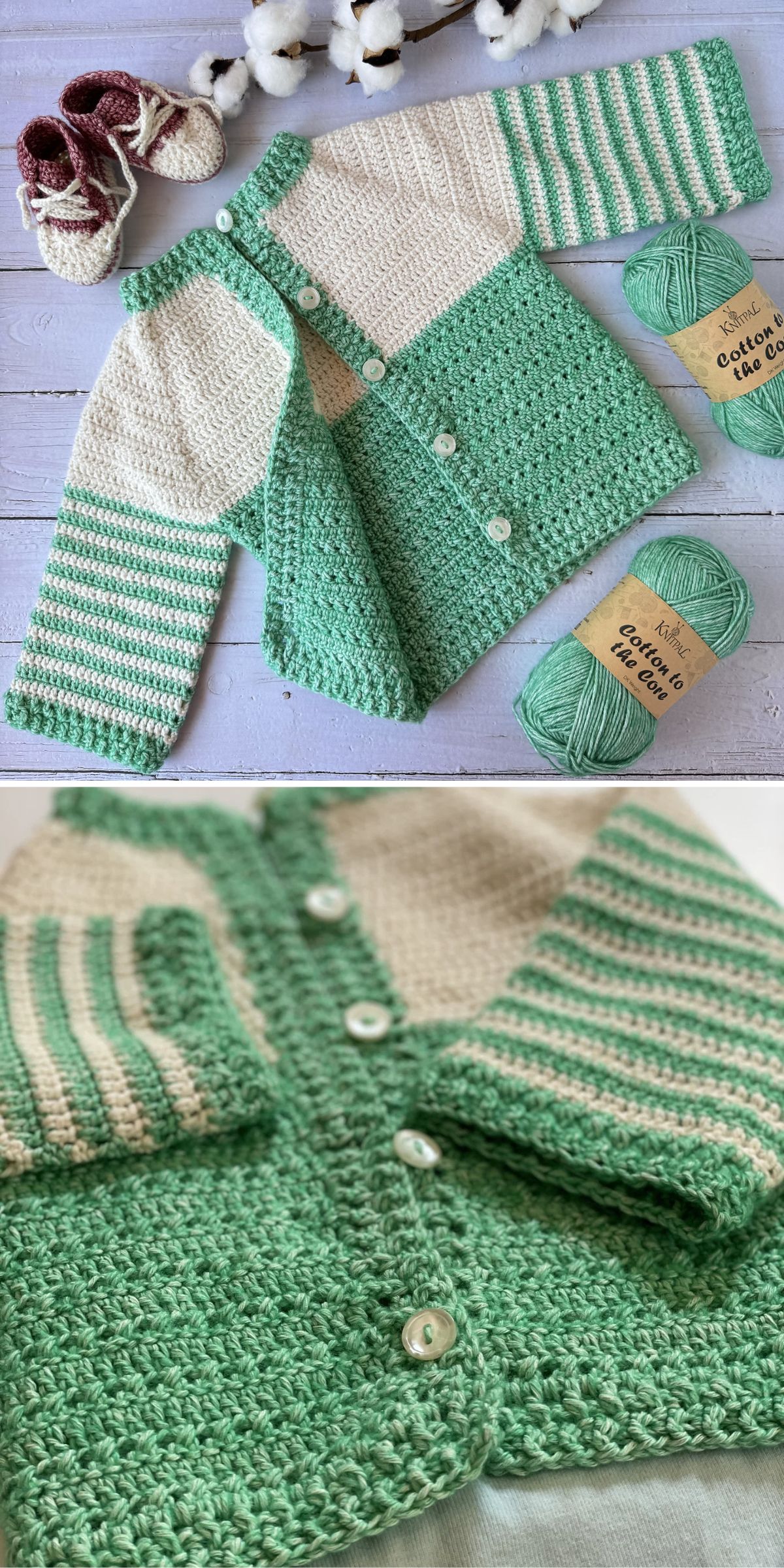 A handmade green and cream crochet baby sweater with striped sleeves is displayed with matching yarn balls, buttons, and a pair of small knitted booties on a light wooden surface.