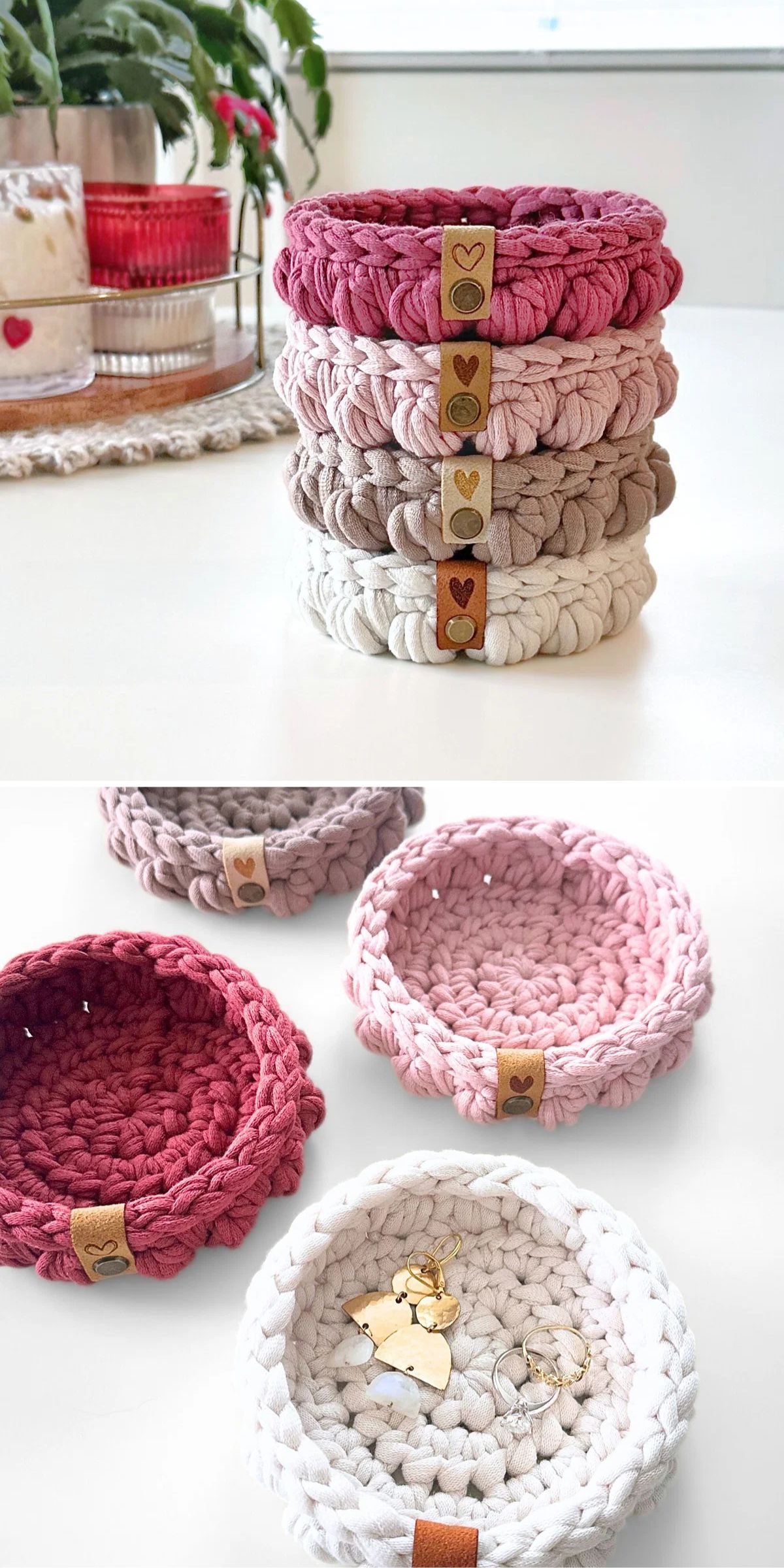 Four round, hand-crocheted baskets in shades of pink, beige, and white are stacked and displayed individually, with one holding small gold jewelry.