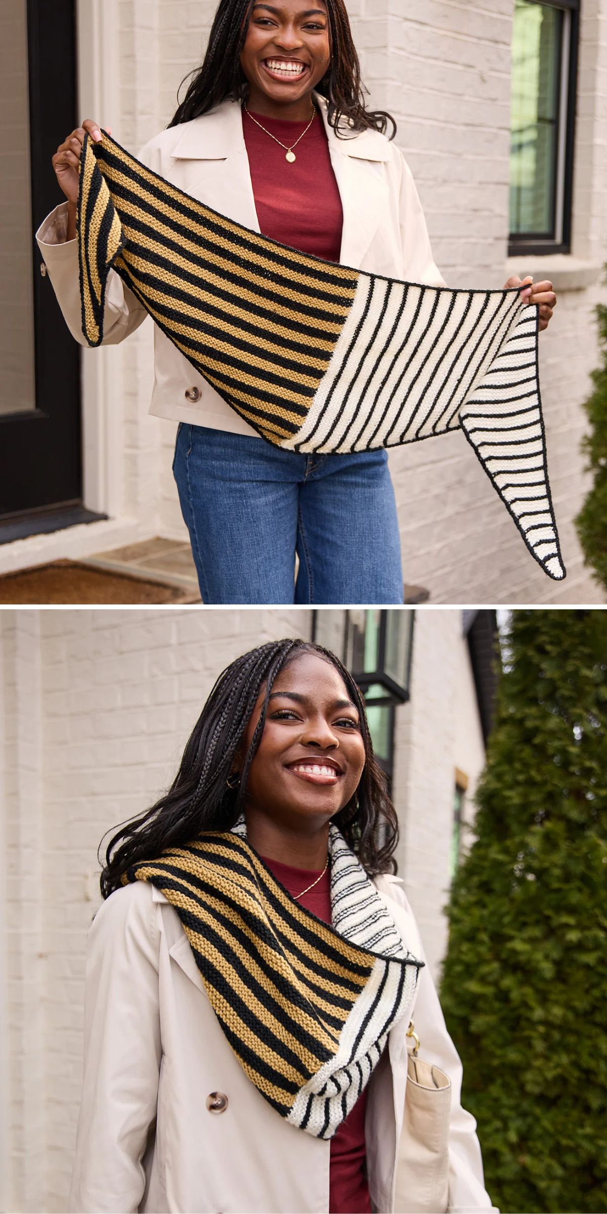A woman holds and wears a striped knit scarf in gold, black, and white, standing outside by a white brick wall and greenery.