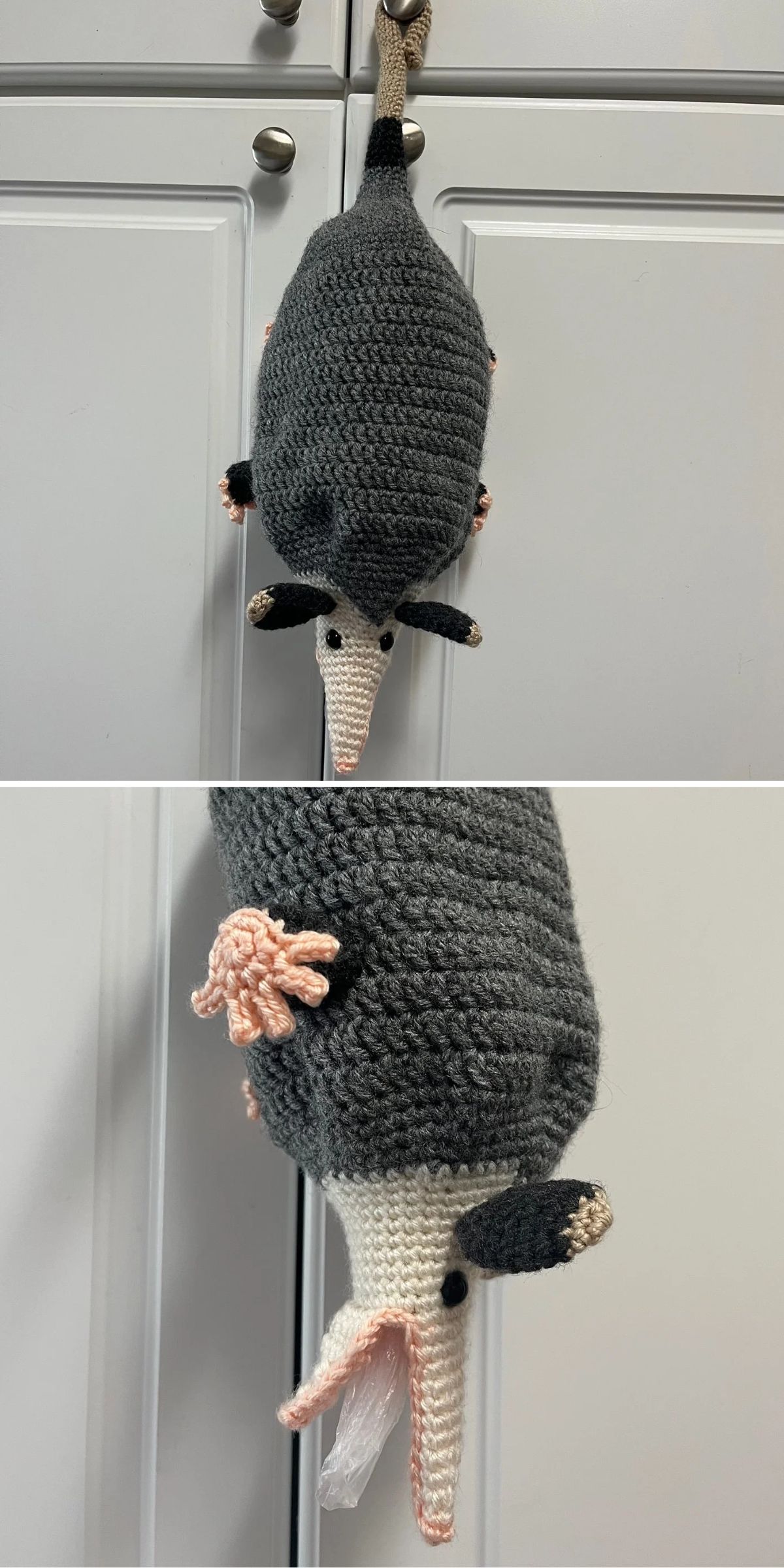 A crocheted opossum-shaped bag holder hangs on a cabinet door, with a plastic bag visible coming out of its mouth.