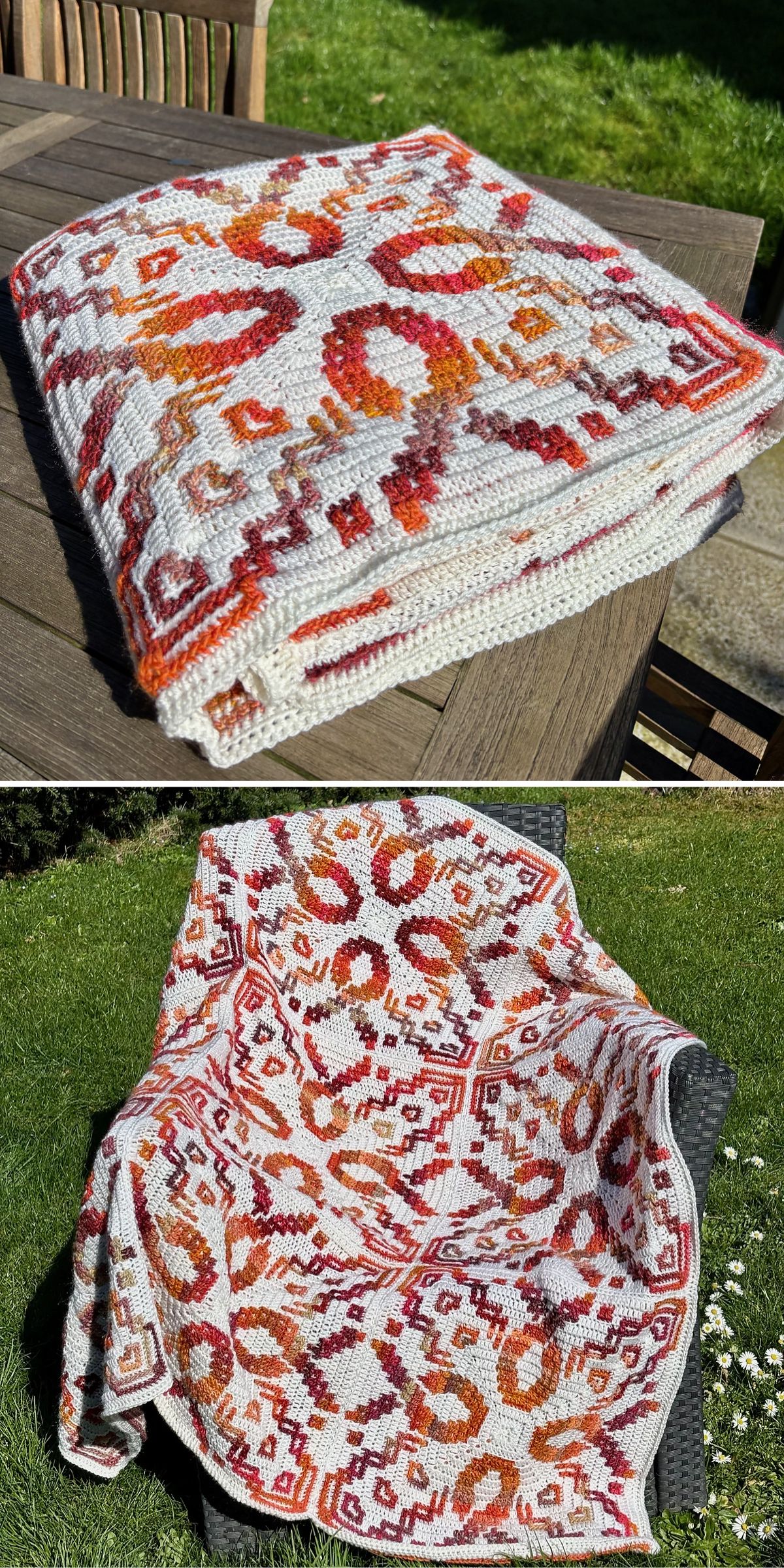 A knitted blanket with an intricate red, orange, and white geometric pattern is folded on a wooden table and draped over a chair outdoors.