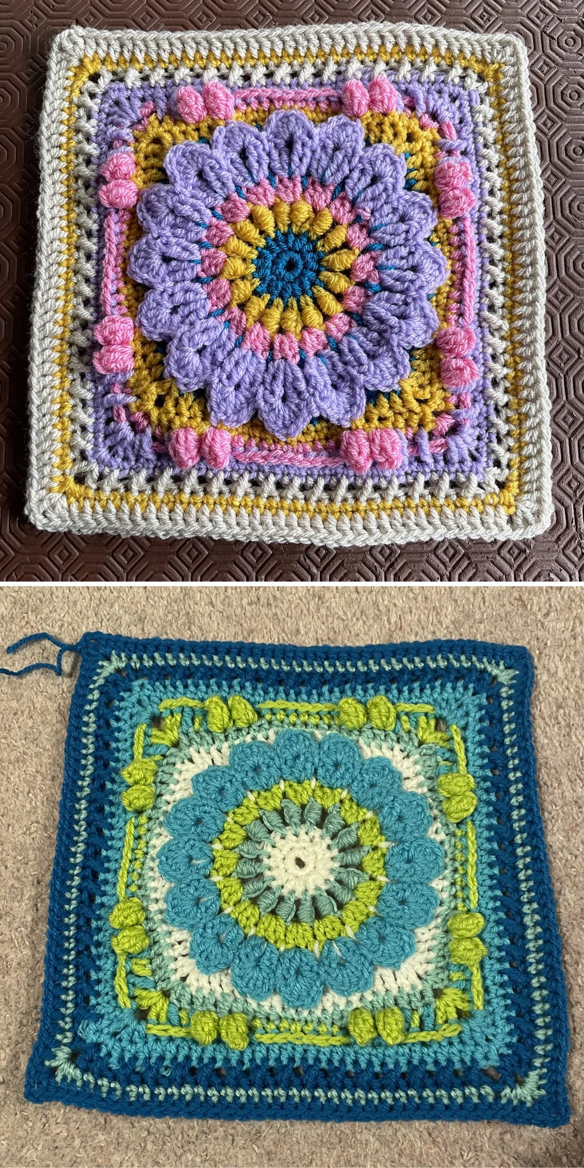 Two crocheted square motifs with flower patterns, one in purple, pink, and yellow tones on a dark pattern background, and one in blue and green tones on a beige carpet.