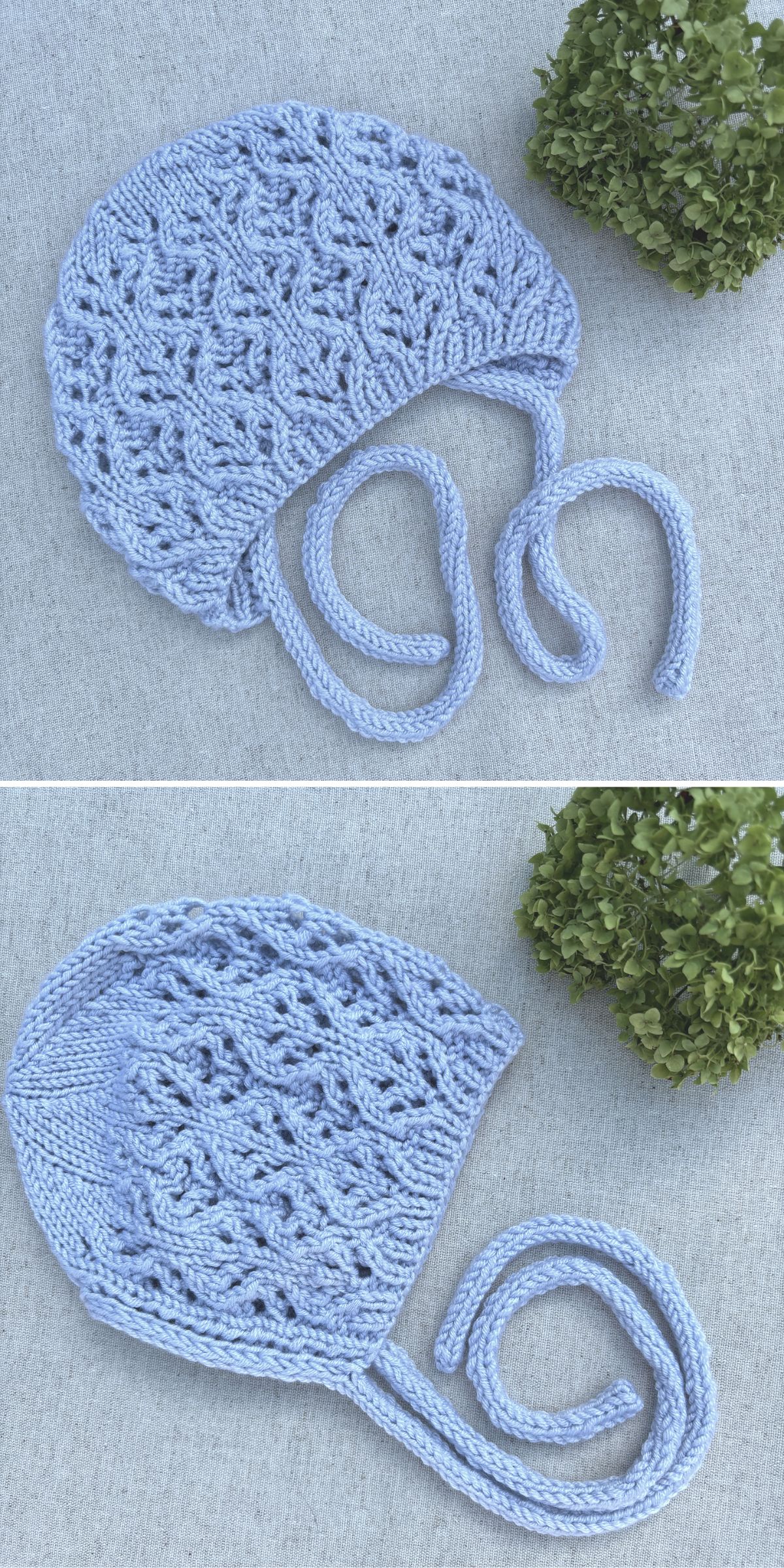 A hand-knitted, light blue baby bonnet with a lace pattern and two ties, displayed on a gray surface next to a small green plant.